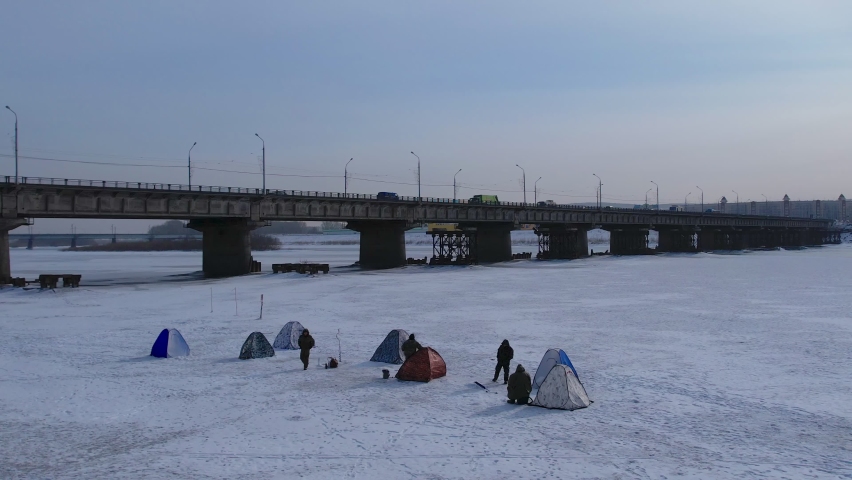 winter fishing on the banks of the Tom River, in the city near the bridge