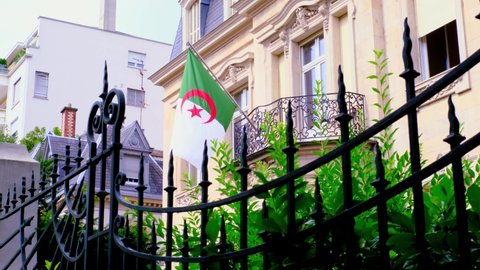 silk national flag of Algeria on facade of building of Consulate General of Algeria in Strasbourg, France, concept of immigration, international relations.