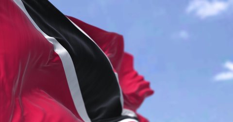 Detail of the national flag of Trinidad and Tobago waving in the wind on a clear day. Trinidad and Tobago is the southernmost island country in the Caribbean. Seamless looping in slow motion