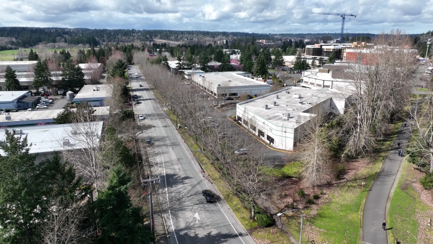 Cinematic aerial drone rise and reveal shot of Redmond Town Center mall, WA-520, apartment construction by Marymoor Park, Lake Sammamish in Redmond, Washington