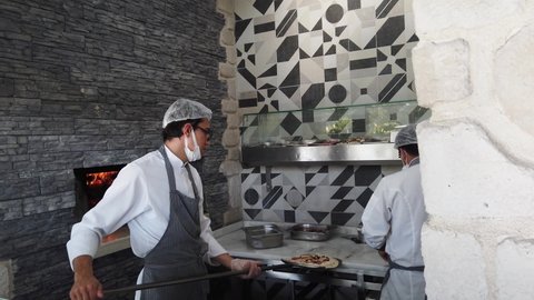 Belek, Turkey, 31 October-2021. Pizzeria staff wearing masks and gloves.