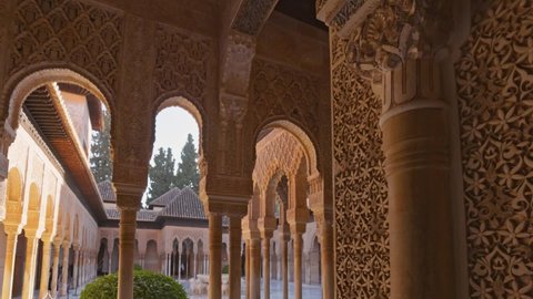 Camera moves between walls and columns with moorish architecture of Court of the Lions, Alhambra, Granada, Andalucia , Spain, Europe. Decorated room and yard in Alhambra, Granada. Gimbal shot, 4K