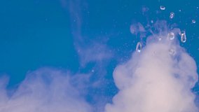 The formation of fog in nature. Climatic processes. Chemical experiments. Movement of smoke on a blue background. Cloud formation. Equalizer, video effect. Alchemy,  Meditation, inspiration