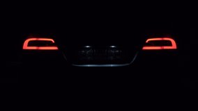 work lights. 4K video. flashing turns. Shots of how the headlights of an electric car glow, the taillights light up and go out STOP