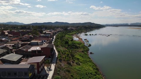 Aeroial footage towards revealing the Walking Street in Chiang Khan then Laos with Mekong River, Loei in Thailand.