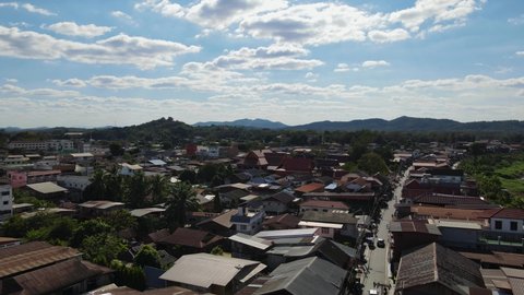 Aerial reverse footage of the city and the Walking Street in Chiang Khan, Loei in Thailand.