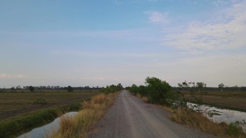 Aerial footage over the farm road as it goes forward and then ascends revealing a lovely landscape, Pak Pli, Nakhon Nayok, Thailand.