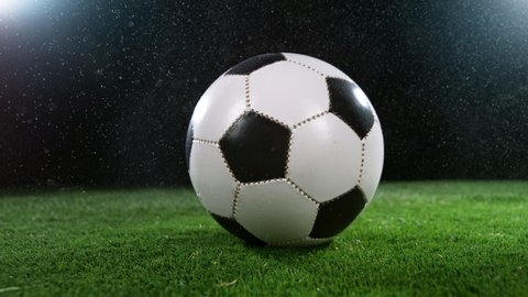 Close-up of Rotating Soccer Ball on Football Field, Super Slow Motion at 1000 fps. Filmed on High Speed Cinematic Camera at 1000 fps.