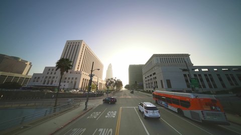 LOS ANGELES, CA, USA - March 15, 2022: City bus, Downtown Los Angeles. Slow motion drone shot. Cars on road in historical center of LA. Concept of urban life commute, travel destination in America.