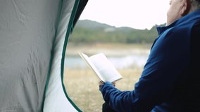 Senior woman reading a book inside tent while camping outdoor in mountain - Elderly people travel in nature concept - Powered by Shutterstock - Get 15% off with code: PIKWIZARD15