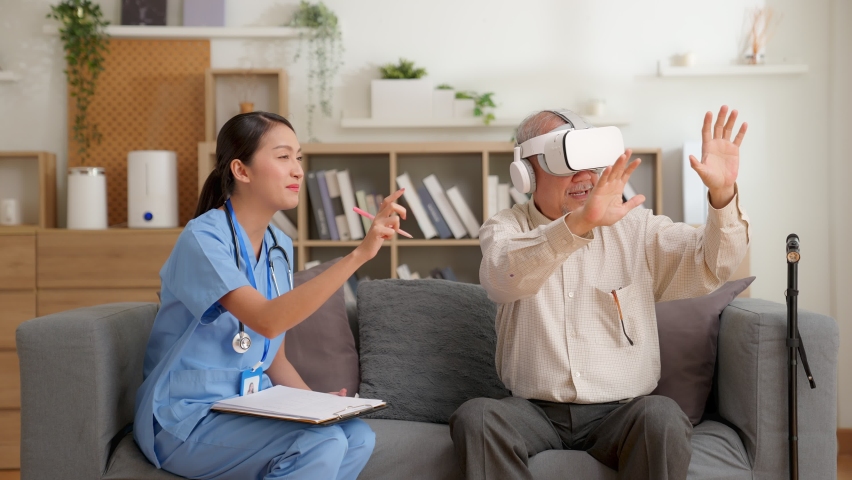Elderly patients using vr glasses and nurse assisting, explain virtual reality technology at home. female doctor and senior man playing virtual game, having fun and enjoy with glasses VR technology. Royalty-Free Stock Footage #1088840401