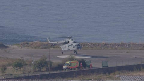 RIJEKA, CROATIA - October 02, 2021 An emergency medical helicopter lands while an emergency medical team and car await