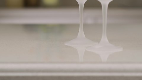Close-up of two empty wine glasses in the kitchen. White wine glasses. Smooth movement of the camera up