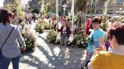 TIMISOARA, ROMANIA - April 20, 2019: TIMFLORALIS international flower festival. People and tourists are enjoying the flower decorations in the city center