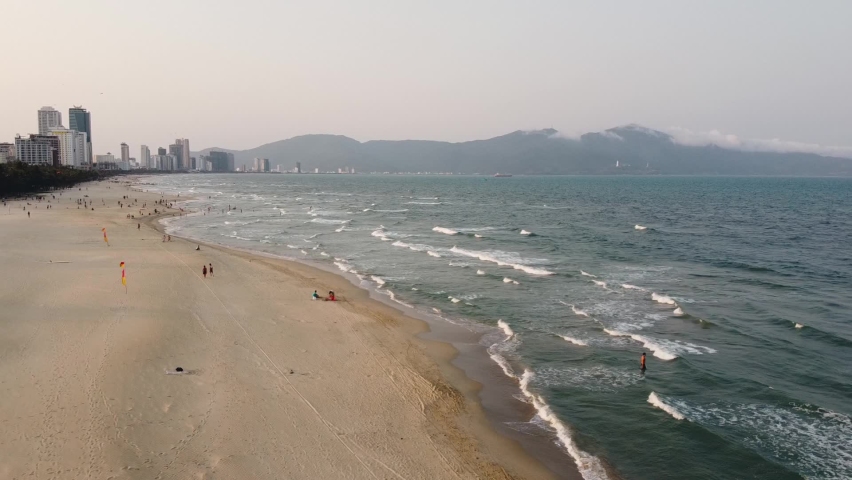 Aerial View Over Tourists and local people gathering at a City beach on weekend.