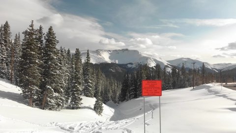 Orange avalanche blast sign on Berthoud Pass in Colorado Rockies