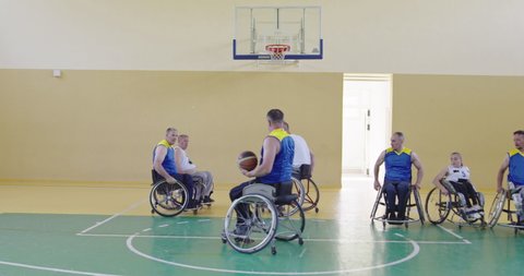 Persons with disabilities play basketball in the modern hallの動画素材