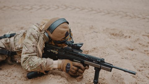 Marine soldier reaching out for a handgun pistol at ground level stance aiming using target scoop . High quality 4k footage