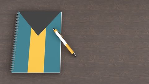 A notebook with the flag of Bahamas and a lying pen, 3d animation