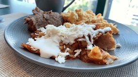 Eating Chilaquiles with Red Sauce