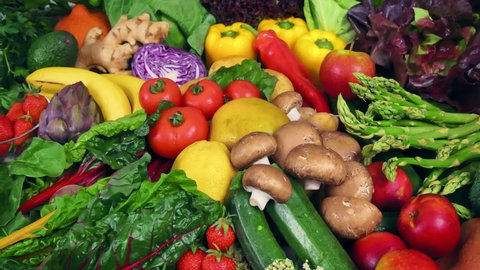 Colorful bunch of fresh vegetables and fruits with the camera moving around them. Symbol of healthy lifestyle and nutritious plant-based eating 
