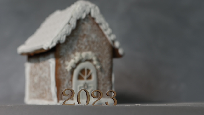 gingerbread house in the background and 2023 in the foreground. Beautiful shadows.