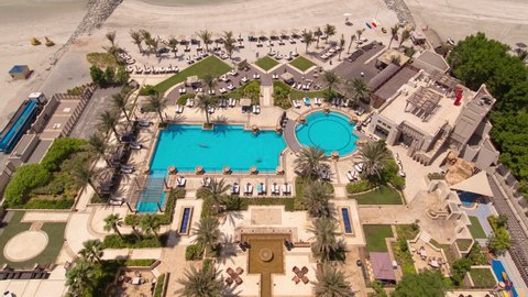 Beautiful area of beach in Ajman timelapse near the turquoise waters of Arabian Gulf, UAE. Panoramic rooftop view with swimming pool