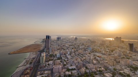 Sunrise with cityscape of Ajman from rooftop aerial panoramic timelapse. Ajman is the capital of the emirate of Ajman in the United Arab Emirates.