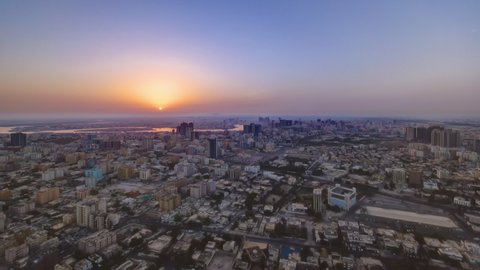 Sunrise with cityscape panorama of Ajman from rooftop aerial timelapse. Ajman is the capital of the emirate of Ajman in the United Arab Emirates.