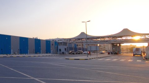 Sunset at free zone of Ajman timelapse. Gate at the entrance. Ajman is the capital of the emirate of Ajman in the United Arab Emirates.