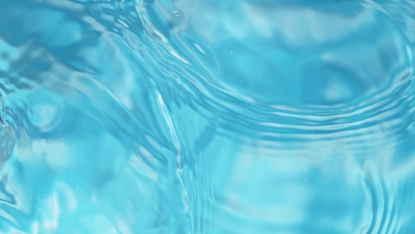 Super slow motion of water surface on light blue background. Filmed on high speed cinema camera, 1000 fps. Royalty-Free Stock Footage #1088863931