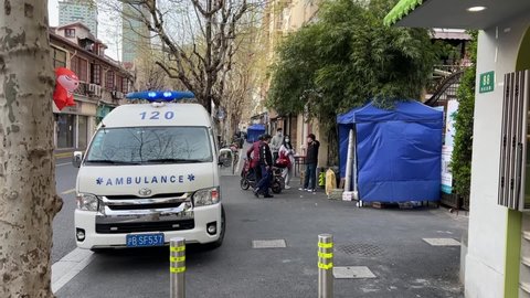 SHANGHAI, CHINA - MARCH 31, 2022: Ambulance next to covid control tent