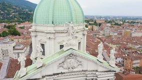 Inscription on video. Brescia, Italy. Cathedral of Santa Maria Assunta. Flight over the city in cloudy weather. Shimmers in colors purple, Aerial View, Departure of the camera