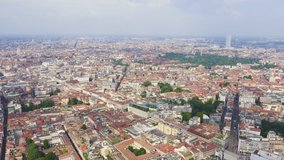 Inscription on video. Milan, Italy. Roofs of the city aerial view. Cloudy weather. Lightning strikes the letters, Aerial View