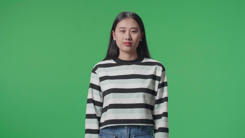 Proud Asian Woman Touching Her Chest While Standing In Front Of Green Screen Background  
 Royalty-Free Stock Footage #1088875379