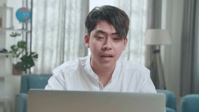 Close Up Of Asian Man Student Having Video Call While Using Computer To Study Online At Home
