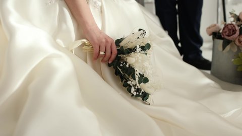 bride holding a wedding bouquet in her hand	