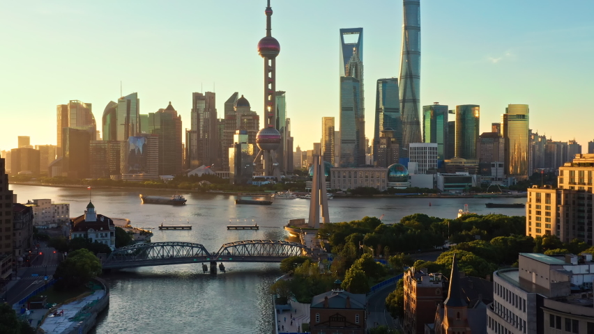 Aerial footage of city skyline and modern commercial buildings in Shanghai at sunrise, China. World famous city skyline in Shanghai.  Royalty-Free Stock Footage #1088876947