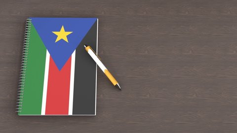 A notebook with the flag of South Sudan and a lying pen, 3d animation