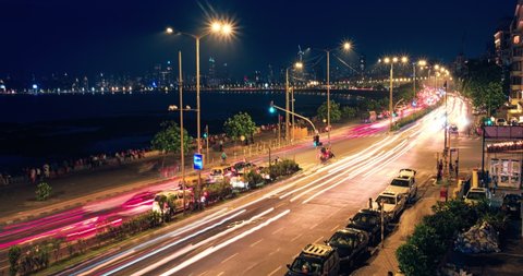 OCTOBER 30, 2019 - MUMBAI, INDIA: Timelapse of Mumbai famous iconic tourist attraction Queen's Necklace Marine drive in the night with car light trails. Mumbai, Maharashtra, India