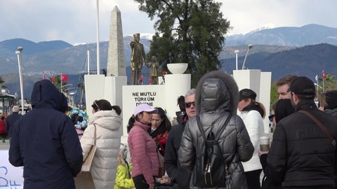 Fethiye, Turkey - 11th of March 2022: Meeting against Putin - 4K Ataturk statue and people gathering for protest meeting against the war
