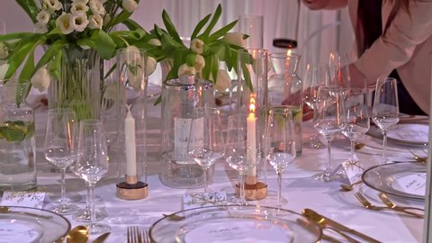 Szczecin City, Szczecin  Poland - February 22 2022: Beautiful table set up. Preparing for the wedding. Flowers and glass on the wedding table. Reception wedding decor. wedding festival