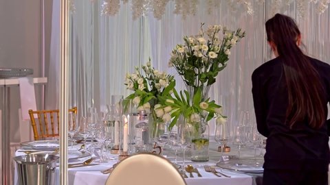 Szczecin City, Szczecin  Poland - February 22 2022: Beautiful table set up. Preparing for the wedding. Flowers and glass on the wedding table. Reception wedding decor. wedding festival
