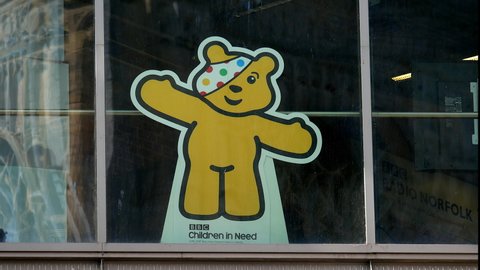 Norwich, Norfolk, United Kingdom. April 3, 2022. BBC Children in Need Pudsey Bear displayed at BBC Studio window at the Forum in Norwich