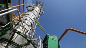 Video panning of refinery tower with blue sky