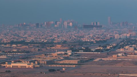Cityscape of Ajman from rooftop early morning timelapse. high rise building on a background during sunrise in the United Arab Emirates.