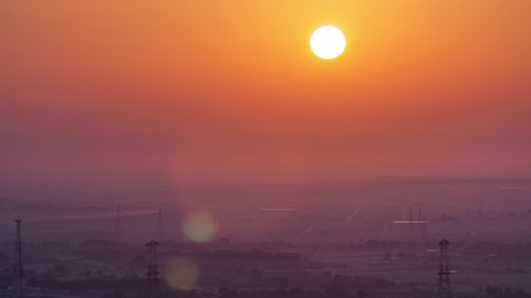 Beautiful sunrise in lonely desert and mountain in the background timelapse, Ajman, UAE Close up view with red sky