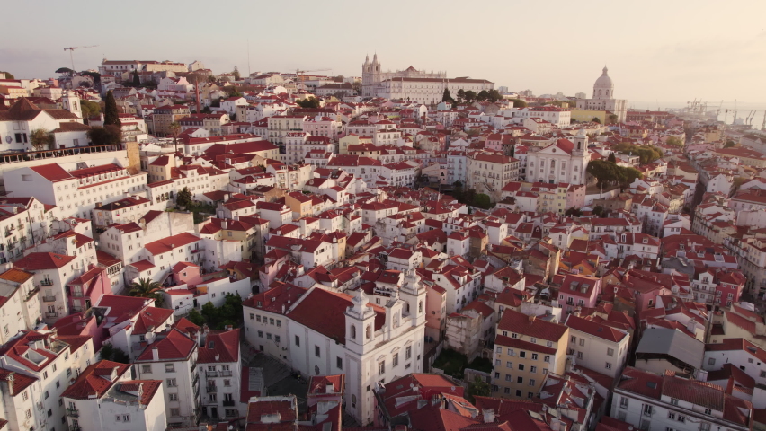 Aerial panoramic view of downtown of Lisbon, Portugal. Drone footage of the Lisbon old town skyline. Historical district Alfama at sunrise in capital city of Portugal Royalty-Free Stock Footage #1088889479