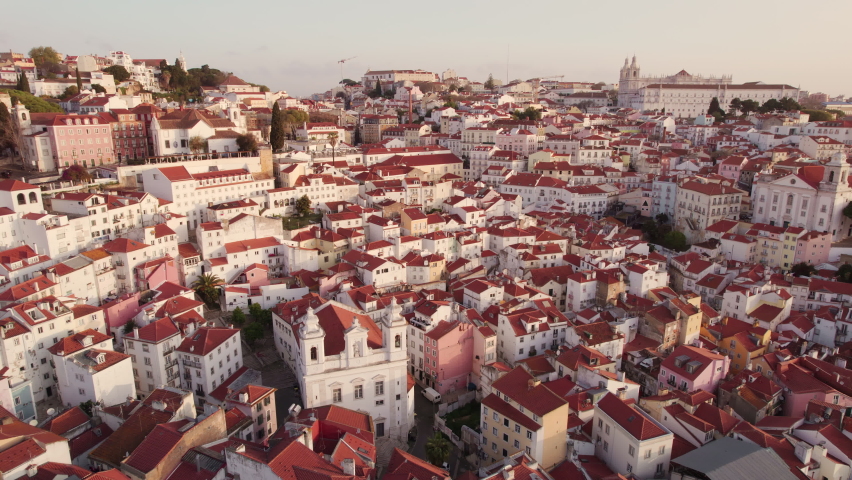 Aerial panoramic view of downtown of Lisbon, Portugal. Drone footage of the Lisbon old town skyline. Historical district Alfama at sunrise in capital city of Portugal Royalty-Free Stock Footage #1088889479
