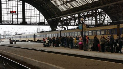 LVIV, UKRAINE - JANUARY 5, 2018: Train departures from Lviv railway station and people waiting on platform, Ukraine. 4K, Editorial, Audio, Handheld